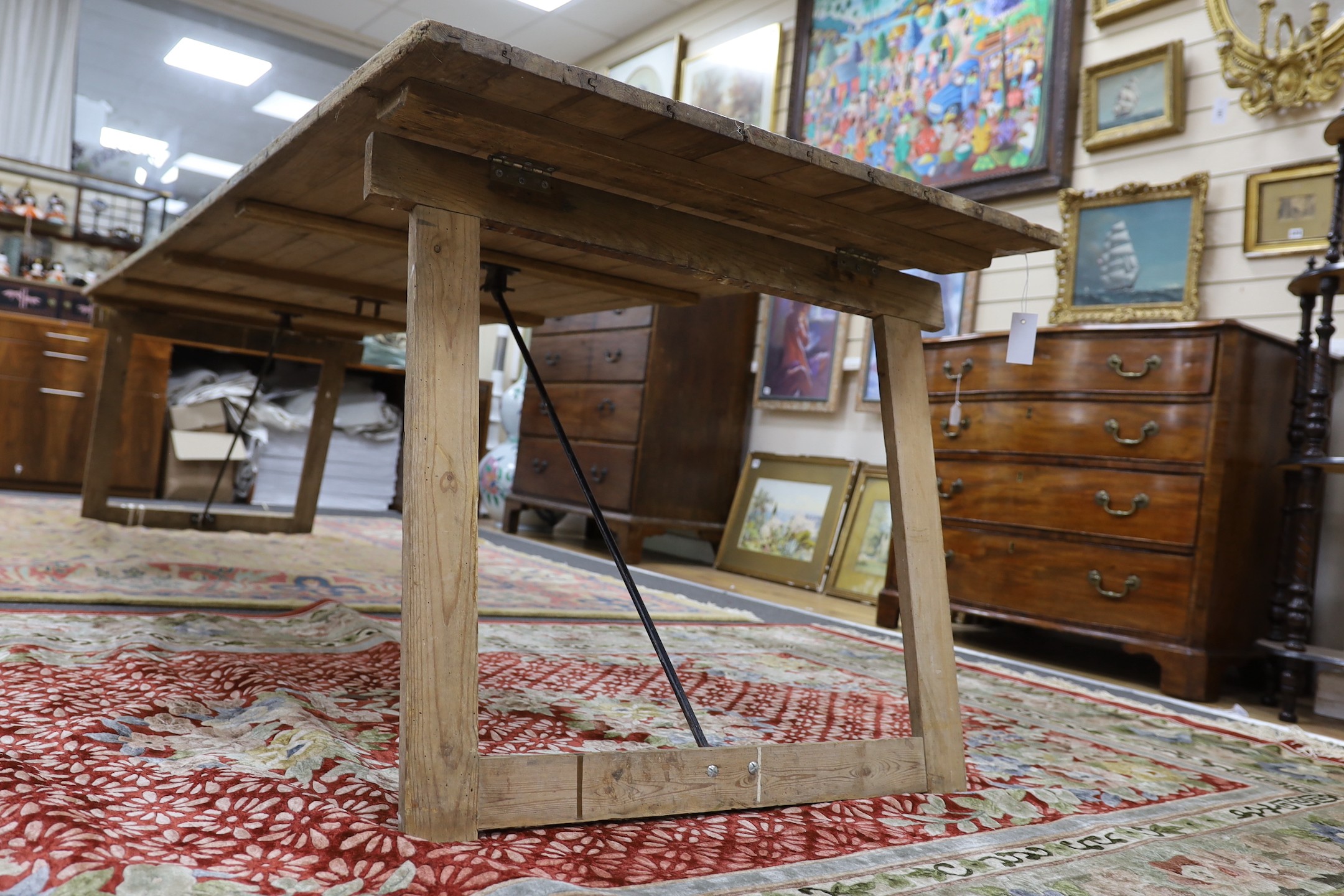 A large French rectangular pine and wrought iron folding trestle table, length 300cm, depth 91cm, height 74cm